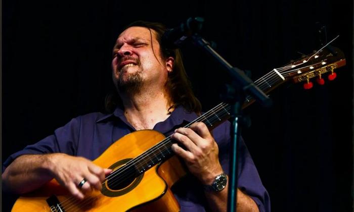 Jonathan Lee Dotson, playing his guitar with zeal