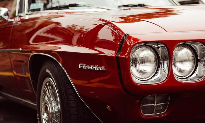 Red Pontiac Firebird with black trim