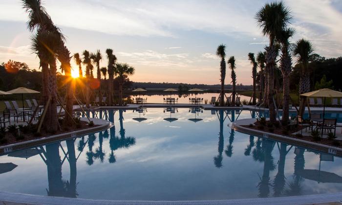 Gradual entry pool with resort-style surroundings and a lake view