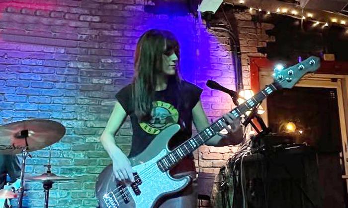 Guitarist Julie Papili onstage with her guitar