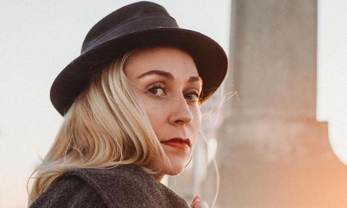 headshot of musician Kyra Livingston, in black bowler hat