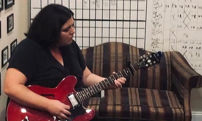 Lauren Chase playing the guitar
