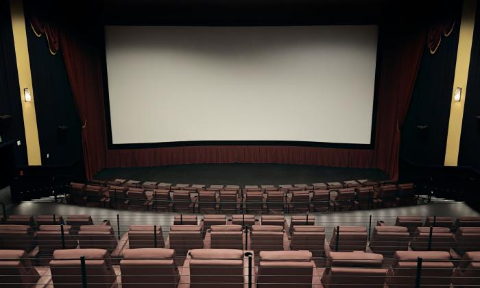 One of the theatres onsite with a wide screen and recliners
