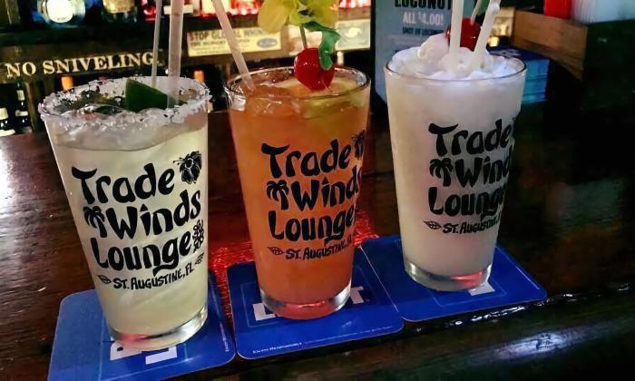 Three tropical drinks from in glasses from Trade Winds Tropical Lounge