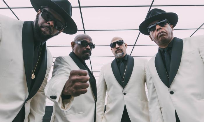 Bandmates from Cypress Hill don white and black suits and pose for fans. 