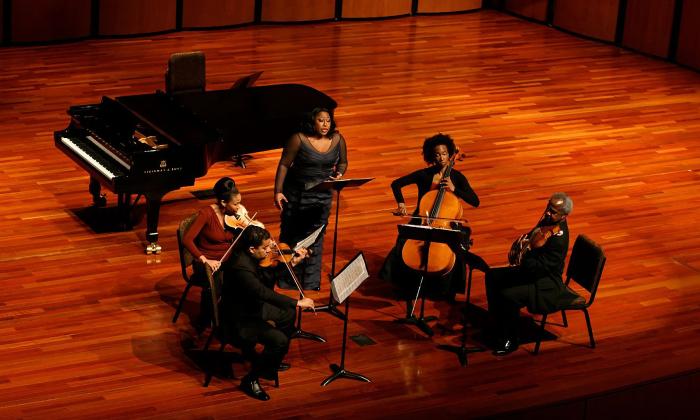 Five members of the Ritz Chamber Ensemble on stage as seen from the balcony