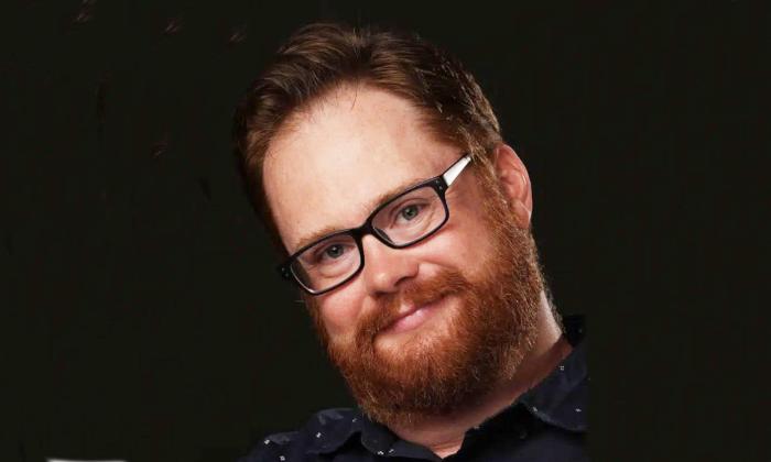 Songwriter Adam Wood headshot, smiling.