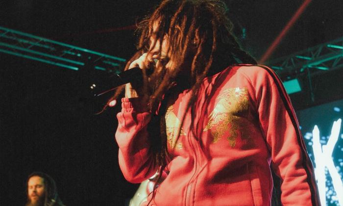 Bandmates from Korn Again perform live on stage.