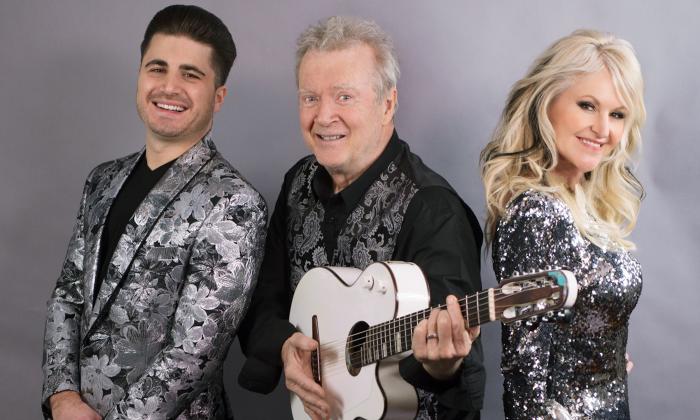 Peter White clutches his guitar and smiles alongside Mindi Abair and Vincent Ingala. 