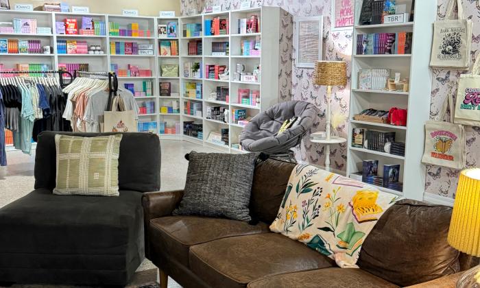 A lounge area with bookshelves lining the walls behind