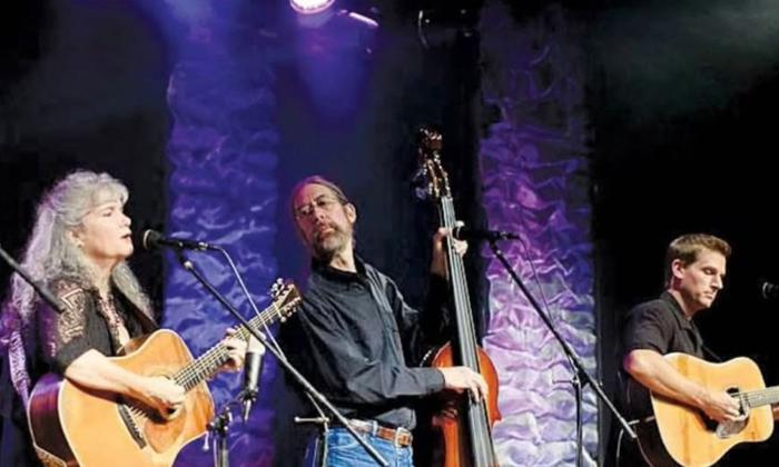 Gatorbone Trio onstage, playing and grinning