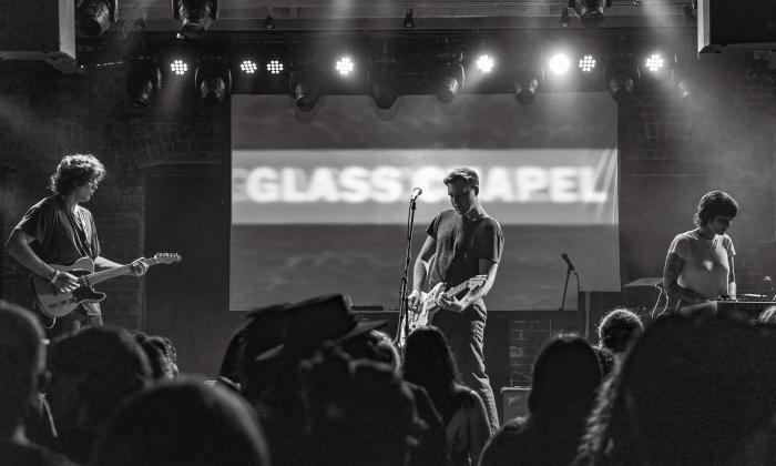 The three members of Glass Chapel on stage in black and white