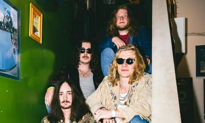 The band Red Magnolia sitting on a staircase