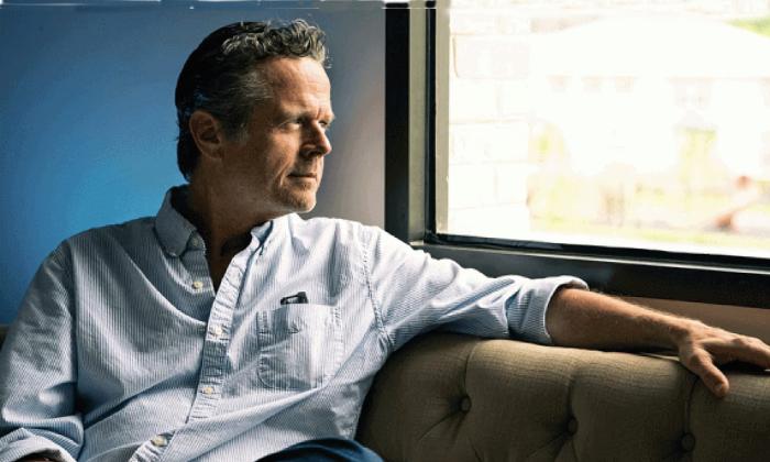Songwriter Jim McCormick siting at a window