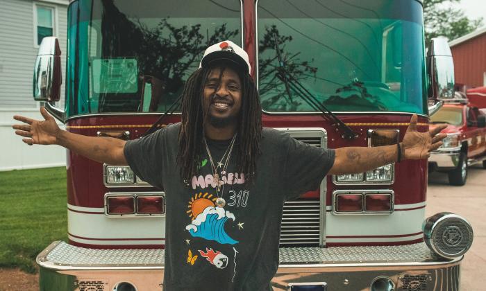 The artist Shwayze in front of his tour bus