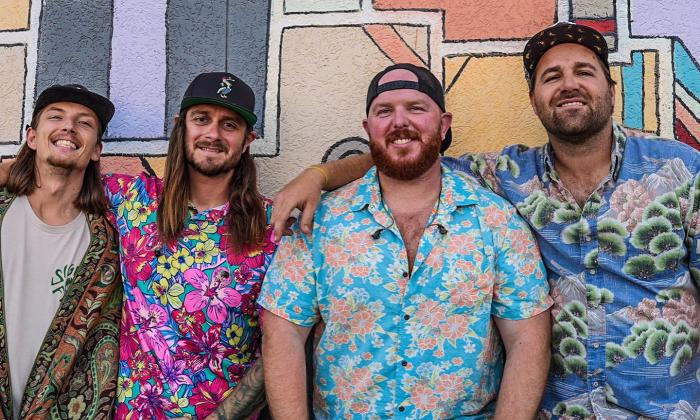 Hulagans band standing together, in hawaiian shirts