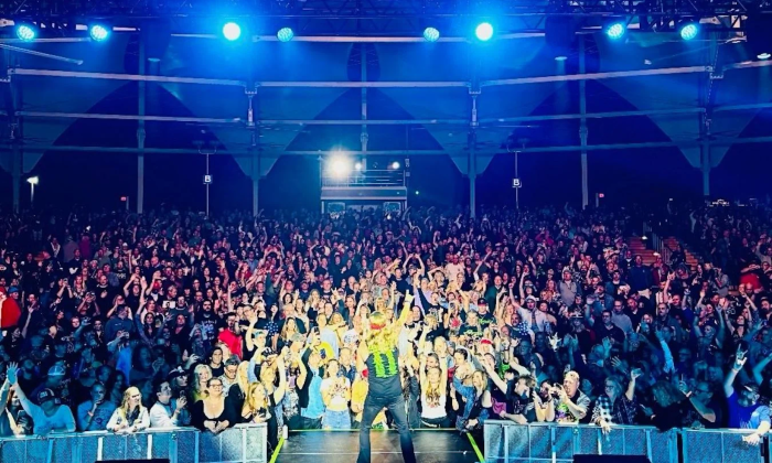 Bret Michaels lifts his hand high as he rocks the stage before a crowd of devoted fans.