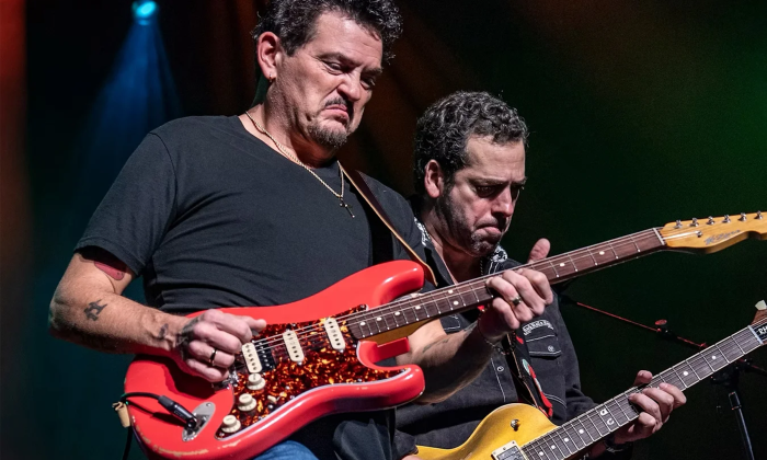Mike Zito and Albert Castiglia wear black shirts and perform on stage.
