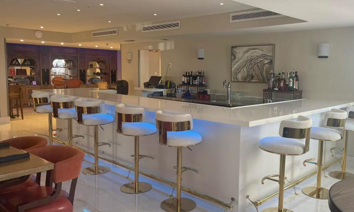 The newly remodeled bar at Avilés Restaurant and Lounge features a white and chrome decor