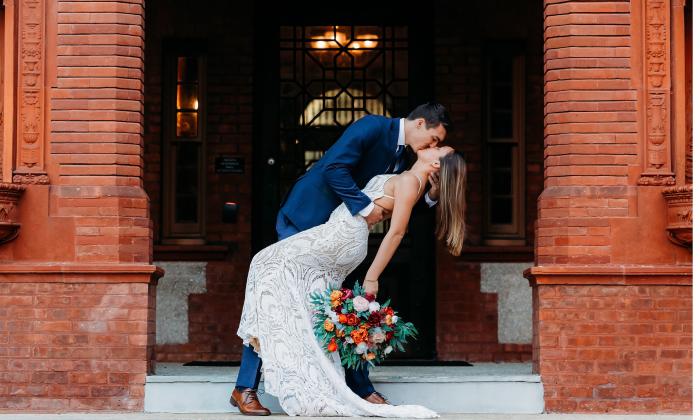 A bride and groom kissing at Flagler College