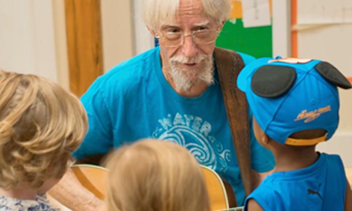 Bob Paterson singing to a group of children