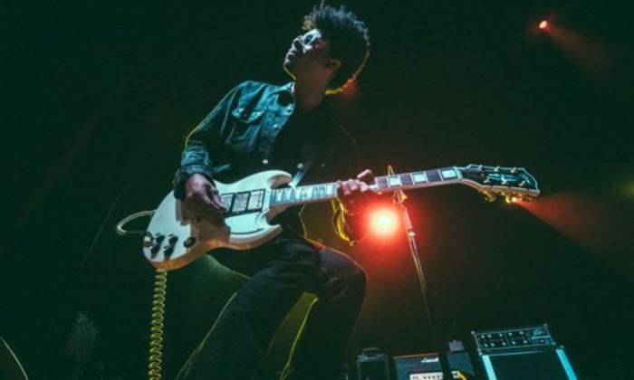 Zach Person performs on stage for audiences.