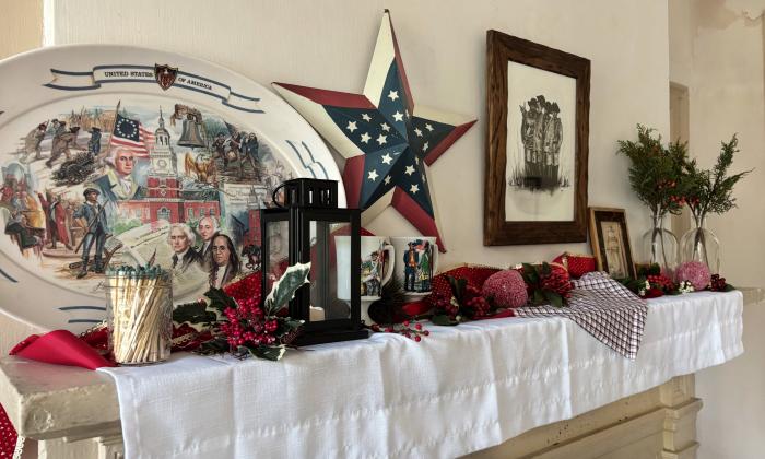 A mantle decorated for the holidays and with a patriotic flair