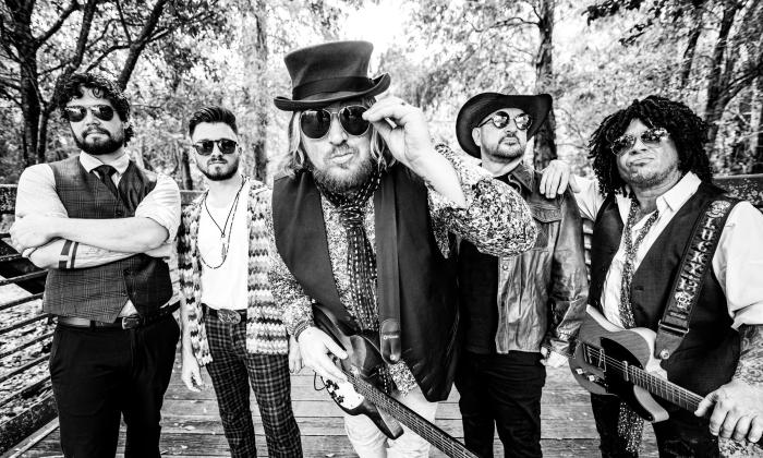 The Broken Hearts, a Tom Petty tribute band, standing outside