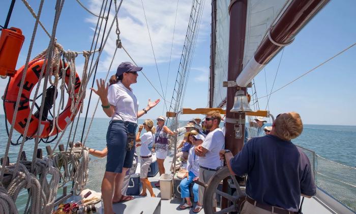 A guide teaching aboard a boat
