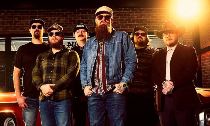 Bandmates from 49 Winchester pose in hats and dark sunglasses.