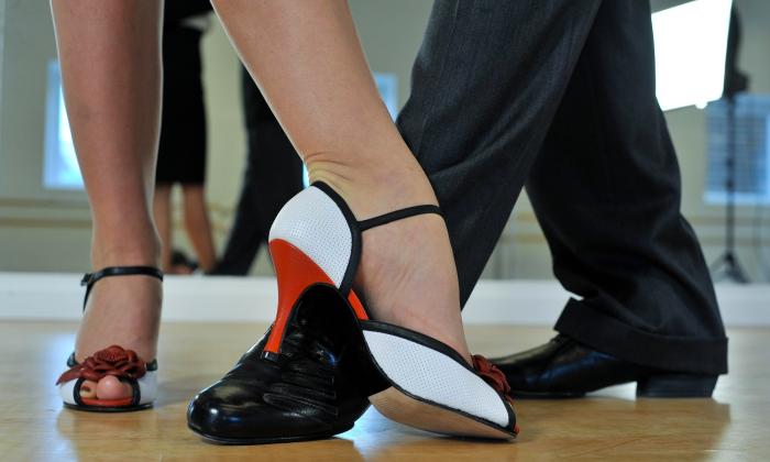A woman in heels and a man in dancing shoes