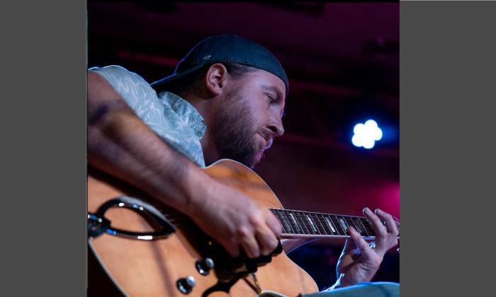 Jim Johnson playing his guitar