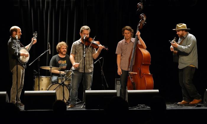 The Wild Shiners on stage in front of a black curtain