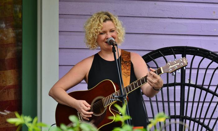 Musician and singer/songwriter Amy Hendrickson playing on a porch