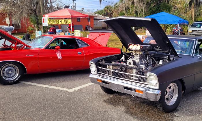 A line of cars with the hood up