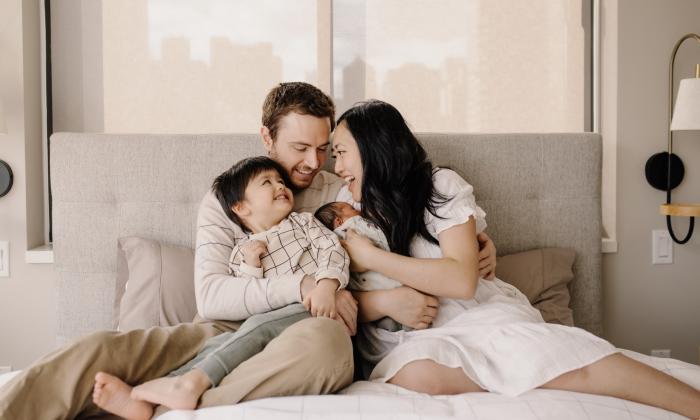 A family of three laughing together