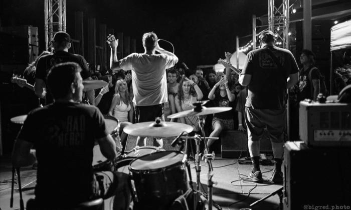 Bandmates from Guttermouth perform live on stage.