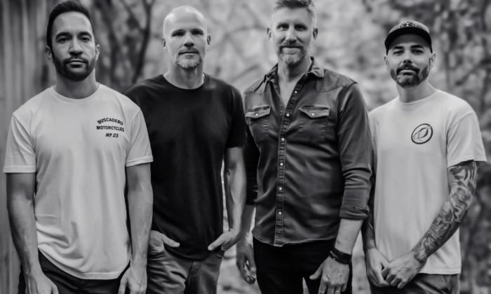 Bandmates from Exhaustra pose in a black and white photograph.