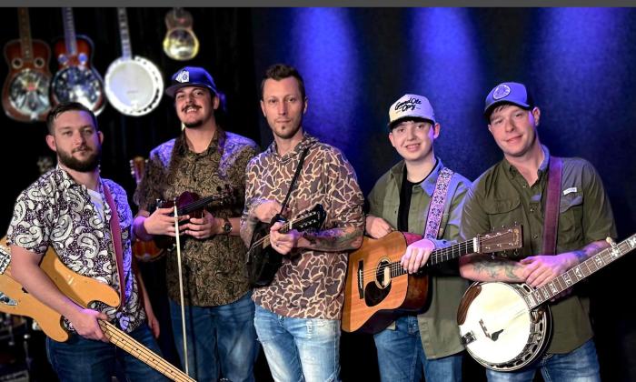 Monroeville Band, standing together, holding instruments. 