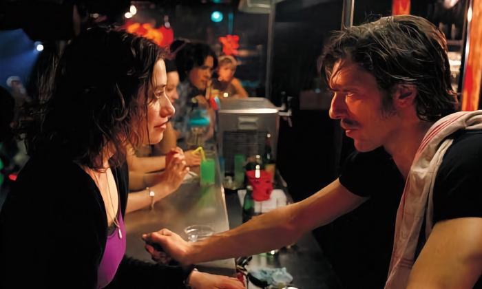 The two characters facing each other at the bar