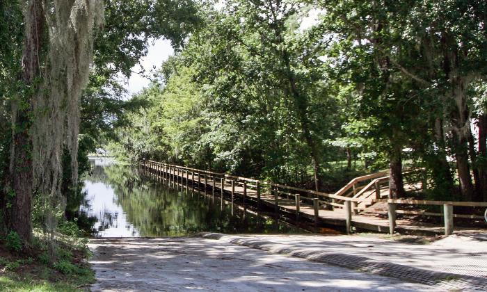 The boat ramp at Trout Creek Park is surrounded by mature trees