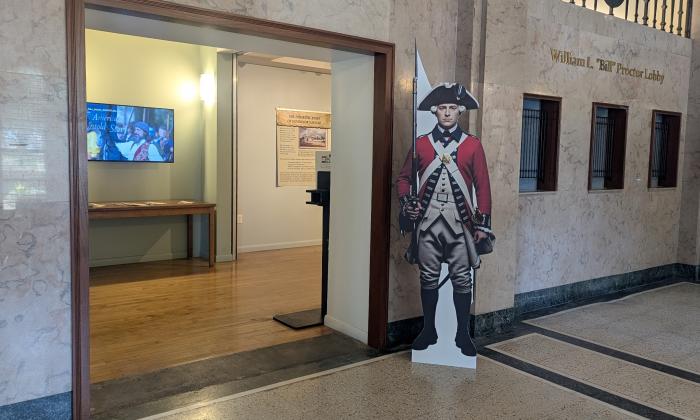 A cardboard British soldier from the Revolutionary War guards the entry to this exhibit