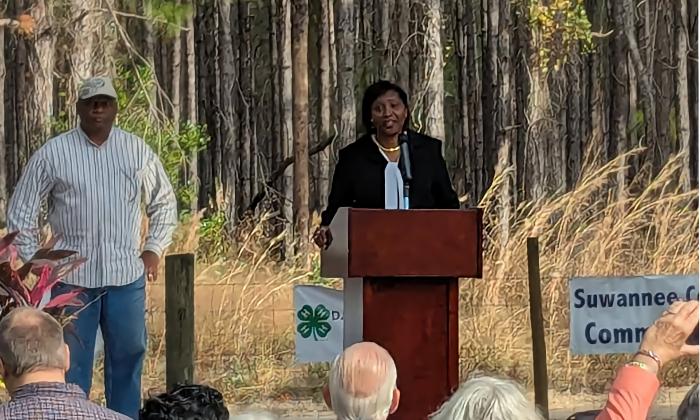 Pat Hines at a podium at the family property