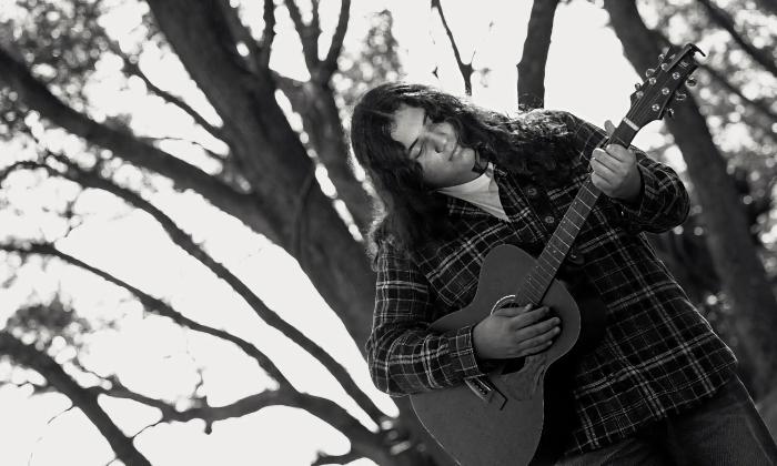 Musician Lane Drix in the winter under stark trees