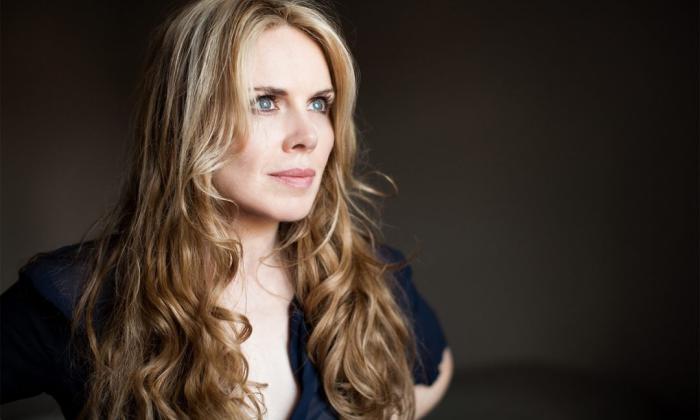 Mary Fahl poses against a black backdrop in a profile shot.