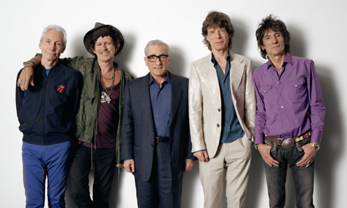 Bandmates from The Rolling Stones pose in front of a white backdrop.