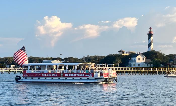 The Pelican vessel for the Red Boat Water Tours going past St. Augustine Lighthouse