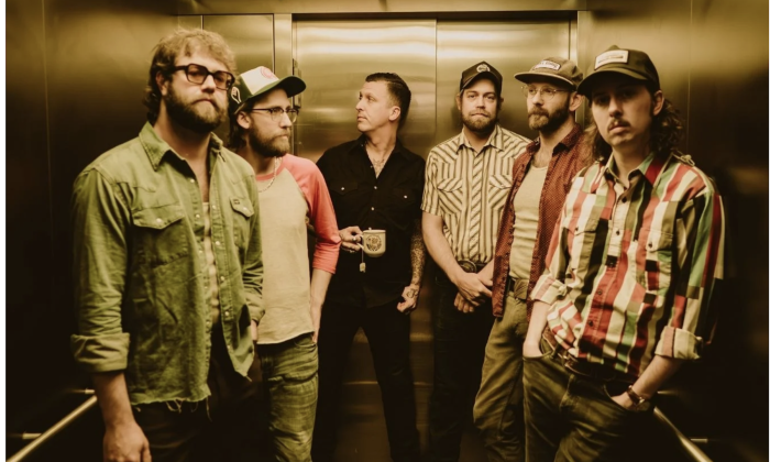 American Aquarium bandmates strike a casual pose inside an elevator.
