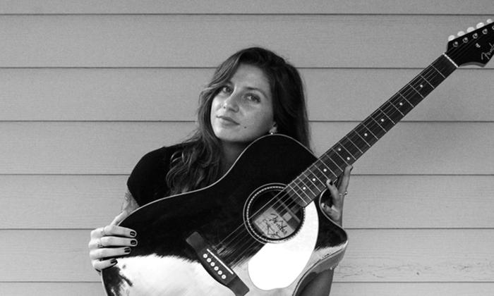 Singer songwriter Francesca Jean with her guitar. 