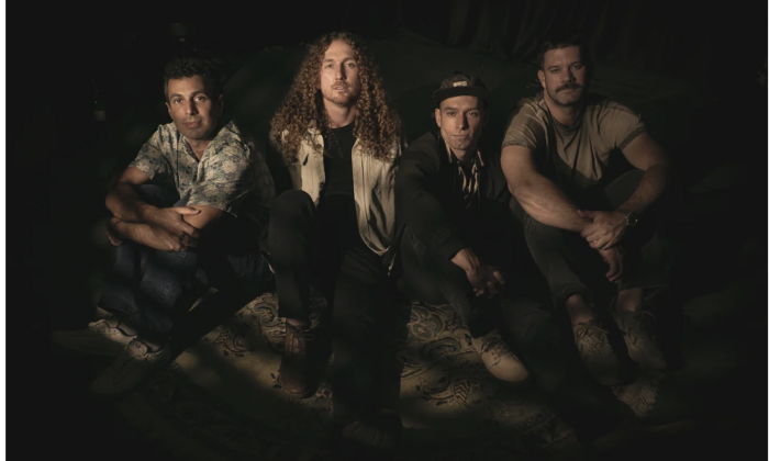 Bandmates from Honey Hounds pose in front of a black backdrop.
